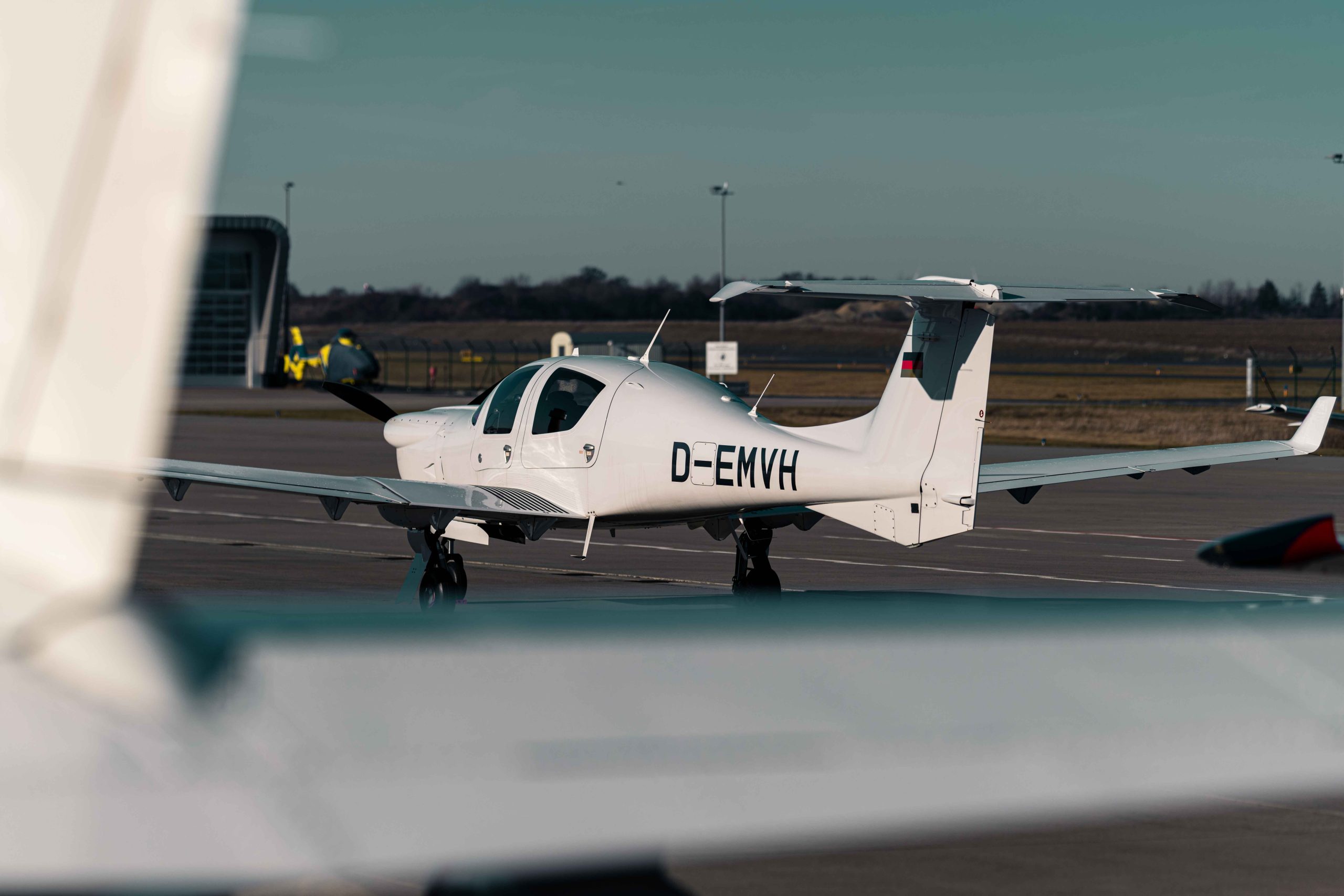 Diamond DA50 RG einmotoriges Reiseflugzeug auf dem Vorfeld eines Flughafens – modernes Design mit Einziehfahrwerk und effizienter Reiseperformance.